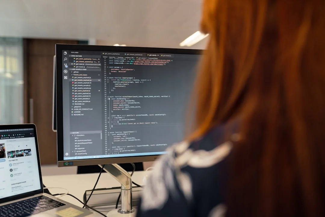 A modern workspace with a smartphone displaying a screen and a computer setup, ideal for business and technology themes.